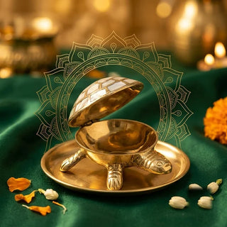 Brass Divya Kachua (tortoise) box on a brass plate with marigold petals on green velvet