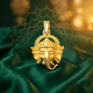 Gold-coloured Impon Ganesha pendant on green velvet