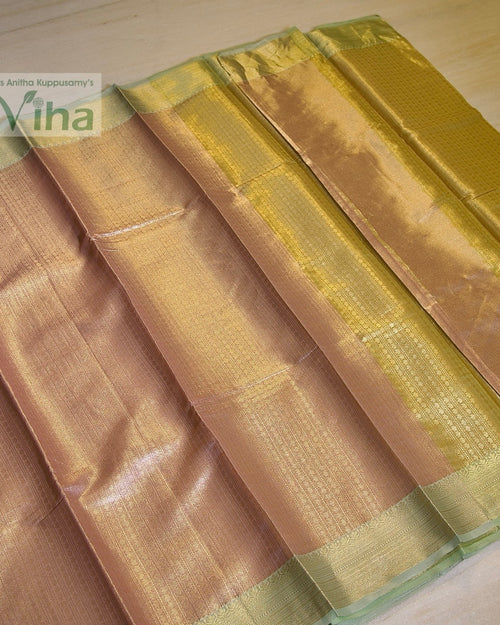 Premium Katan Silk Saree With Blouse, a folded shiny bronze-toned fabric with wide gold-toned patterned borders