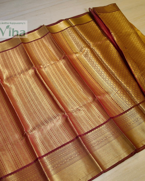 Premium Katan Silk Saree With Blouse, a folded red and gold-toned woven textile featuring ornate geometric patterns