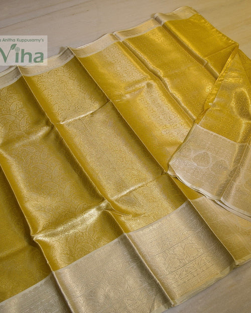 Premium Katan Silk Saree With Blouse, folded yellow-toned textile with a glossy surface finish featuring wide patterned borders