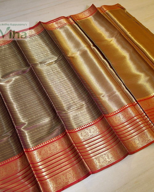 Premium Katan Soft Silk Saree With Blouse, shiny folded fabric with gold-toned patterns and a red border with five parallel lines