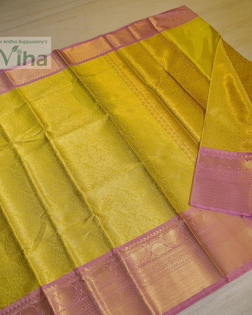 Premium Katan Silk Saree With Blouse, a shiny yellow textile with pink borders and woven patterns