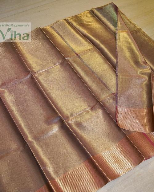 Premium Katan Silk Saree With Blouse, folded gold-toned woven fabric with a shiny surface finish and ribbed border stripes