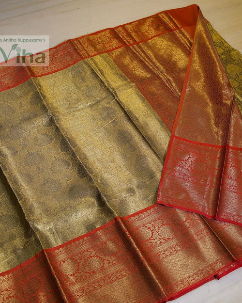 Premium Katan Silk Saree With Blouse, folded green and red fabric featuring metallic patterned borders