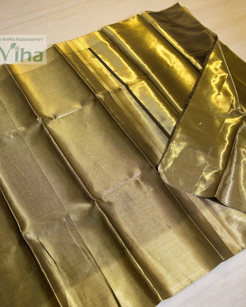 Premium Katan Silk Saree With Blouse, a shiny gold-toned fabric folded with parallel pleats