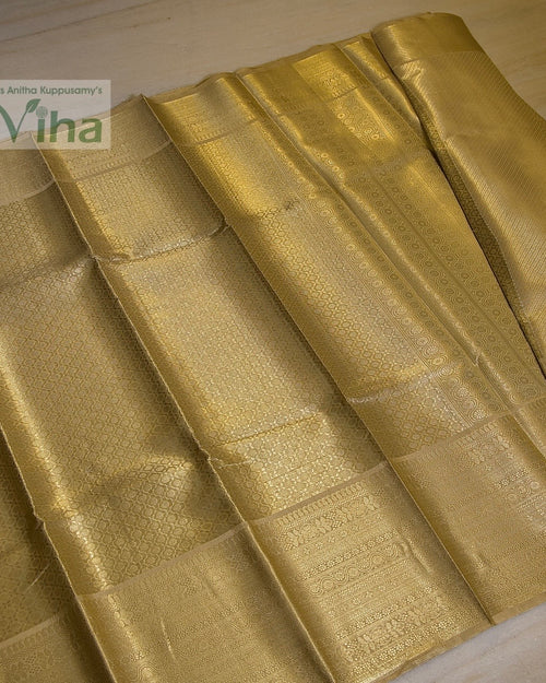 Premium Katan Silk Saree With Blouse, folded gold-toned fabric with intricate woven patterns and glossy finish
