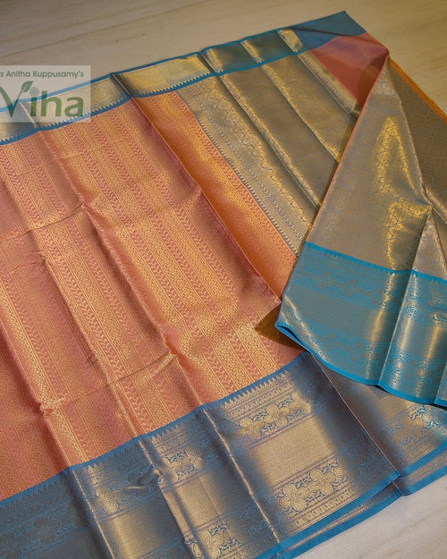 Premium Katan Silk Saree With Blouse, a folded fabric in peach-pink and blue with metallic-toned woven floral and geometric patterns