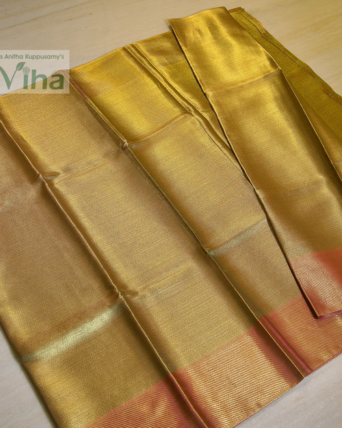 Premium Katan Silk Saree With Blouse, folded shiny gold-toned textile with diagonal ridged borders