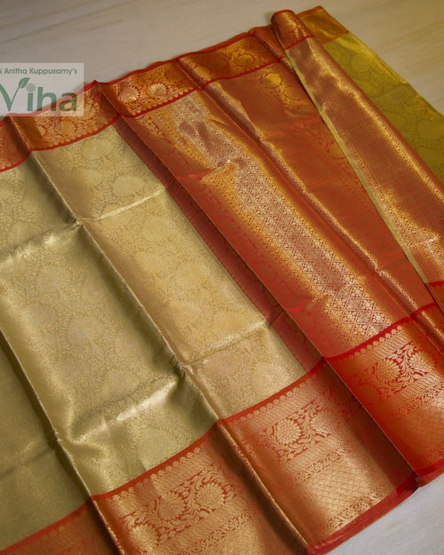 Premium Katan Silk Saree With Blouse, folded gold-toned and red fabric with shiny woven floral patterns and wide patterned borders