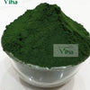 Kubera Green Kumkum, a small transparent bowl containing a dark green powder with a mounded surface