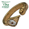 Impon Vel Ring, a gold-toned open band with textured finish, featuring one rounded terminal and one leaf-shaped terminal inset with white and a red stone