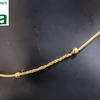 Impon Payal, a gold-toned chain with two round beads and two small dangling charms on a black display form
