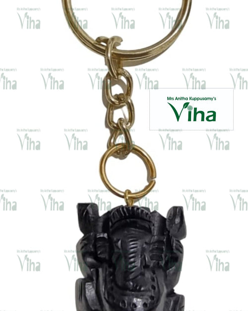 Karungali Wood Ganesha Key Chain, a gold-toned metal keyring holding four chain links and a black carved figure