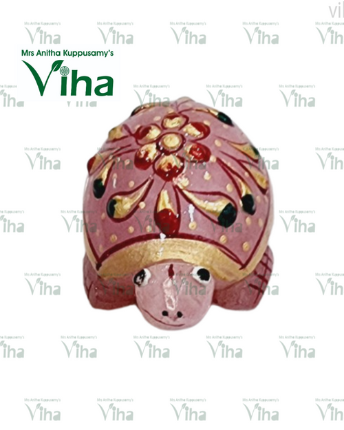 Rose Quartz Turtle, a pink turtle-shaped figure with a glossy finish features gold-toned and red painted floral and teardrop patterns on its domed shell