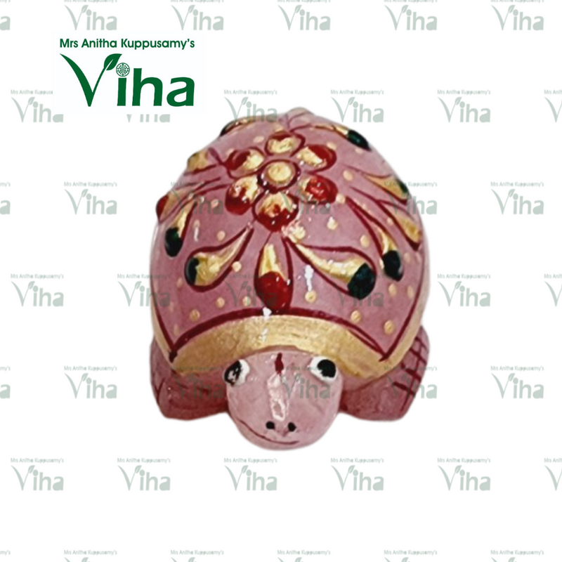 Rose Quartz Turtle, a pink turtle-shaped figure with a glossy finish features gold-toned and red painted floral and teardrop patterns on its domed shell