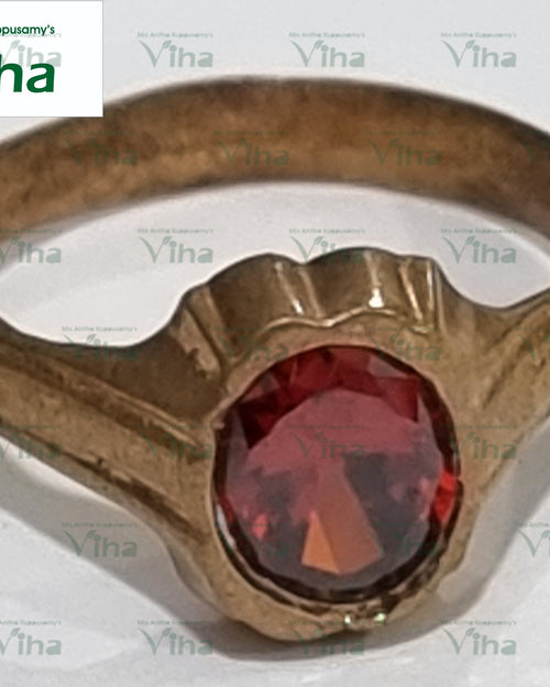 Impon Ring with a faceted oval red stone and ornate metal setting