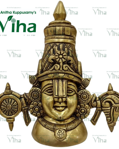 Perumal Face Brass - Wall Hanger, a brass-toned, shiny metal sculpture depicting a face with a tall headdress, flanked by a wheel and conch