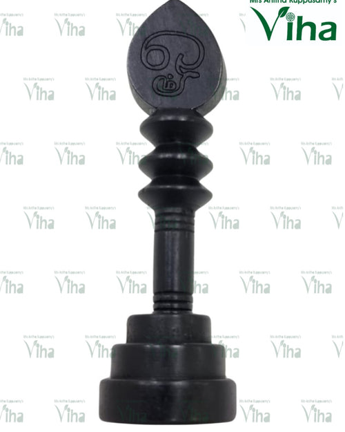 Karungali Wood Vel, a black piece with a pointed oval top carrying engraved symbols, three ribbed sections and a stepped round base