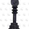Karungali Wood Vel, a black piece with a pointed oval top carrying engraved symbols, three ribbed sections and a stepped round base