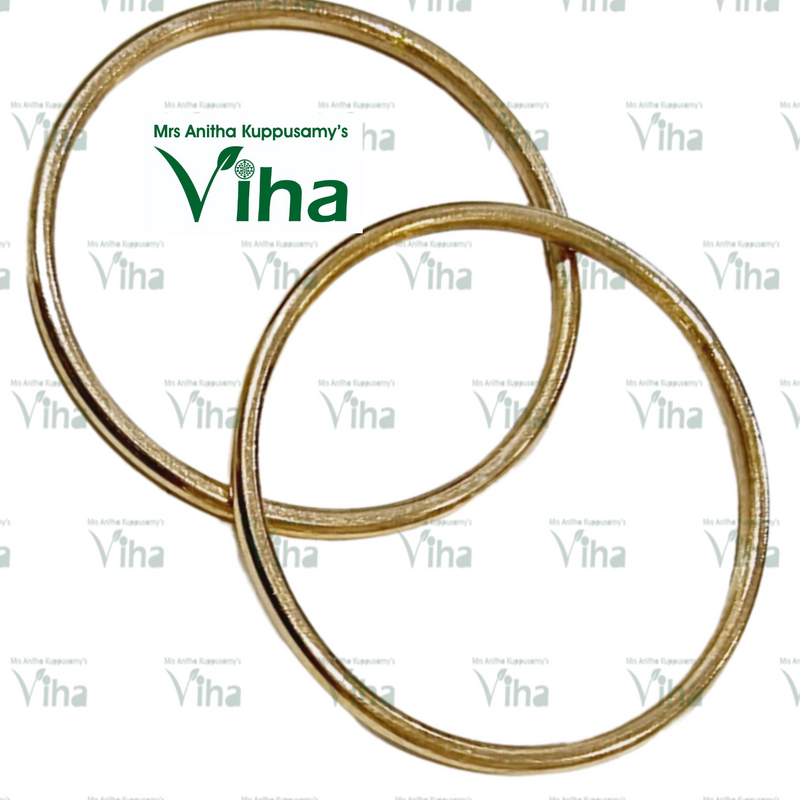 Impon Bangle, two gold-toned, smooth, circular bangles are shown overlapping on a white background
