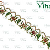 Swastik Thoran, an ornate gold-toned hair accessory featuring alternating green-and-red-enameled swastika and leaf motifs linked by small white bead strands