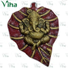 Leaf Ganesha Wall Hanger, a gold-toned figurine featuring four arms and an elephant head, set against a red, textured leaf-shaped plaque