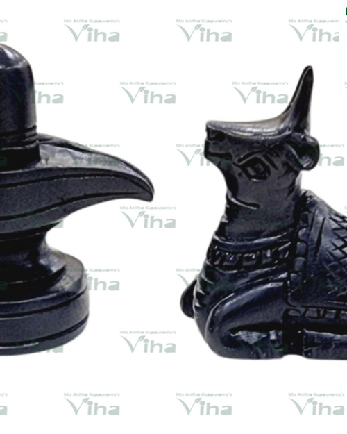 Karungali Wood Shivling Nandi Set, two dark grey polished stone figurines including a rounded pillar and a seated animal with textured blanket