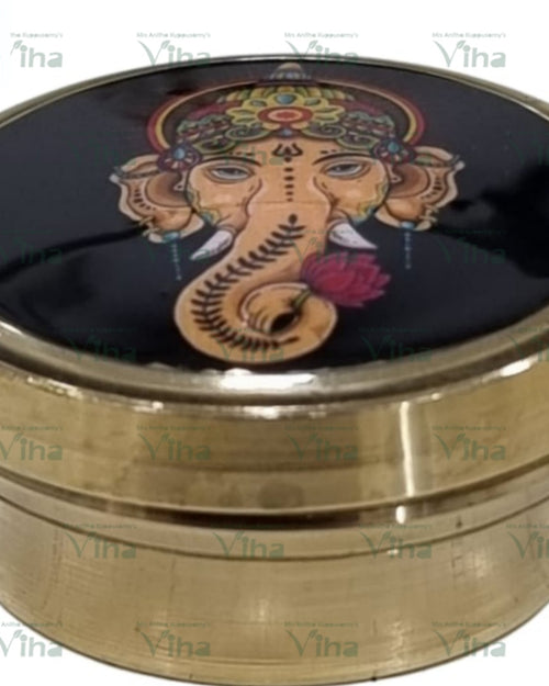 Ganesha kumkum Box, brass covered container with face in relief and concentric ring bands around body