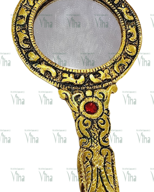 Hand Mirror, a gold-toned hand-held mirror featuring an ornate, textured frame and handle with one red stone embedded in the handle