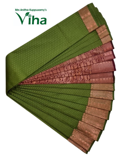 Soft Semi Silk Saree with Blouse, a green folded fabric featuring a patterned orange-toned border with geometric squares and paisley designs