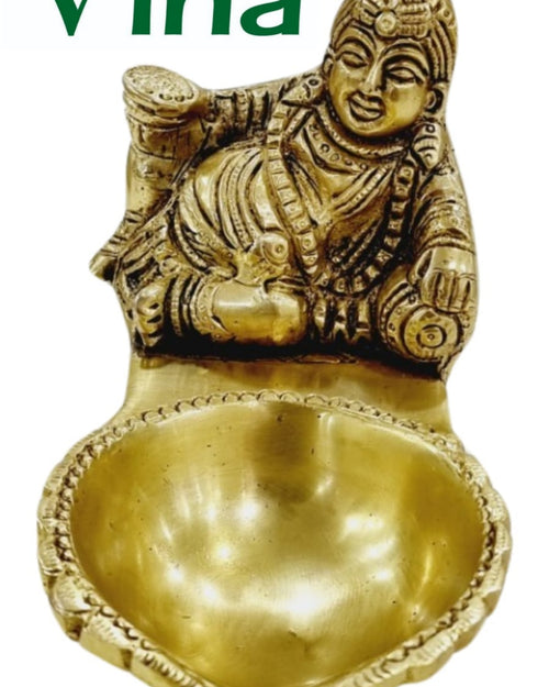 Kubera vilakku in brass, reclining Kubera figure above a broad teardrop oil bowl with a beaded rim