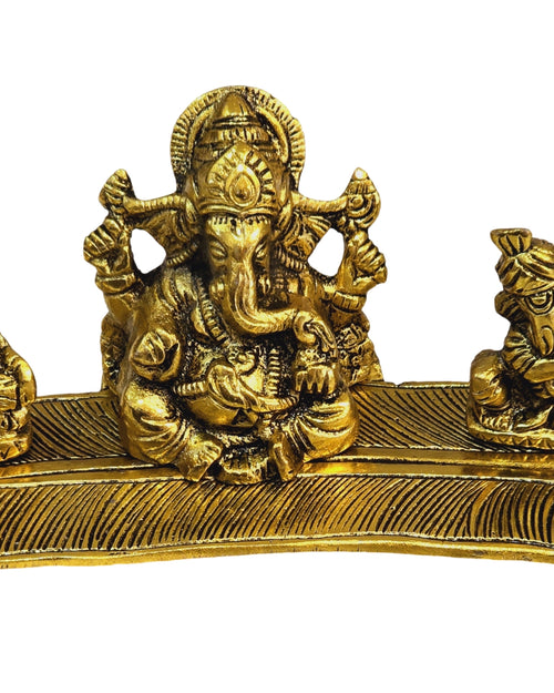Ganesha group on a leaf-shaped base, a larger elephant-headed figure seated between two smaller seated figures
