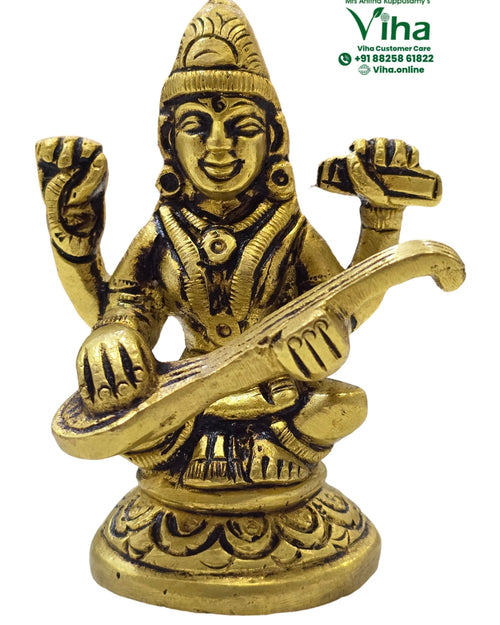 Saraswathi in brass, four-armed figure seated on a round scalloped base playing a veena across the body