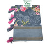 Fancy Cotton Silk Saree With Blouse, a folded grey fabric featuring pink floral prints and four pink-and-grey tassel bundles attached to one edge