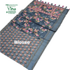 Fancy Cotton Silk Saree With Blouse, a folded dark grey fabric with pink and yellow floral print and a solid border with multi-coloured tassels