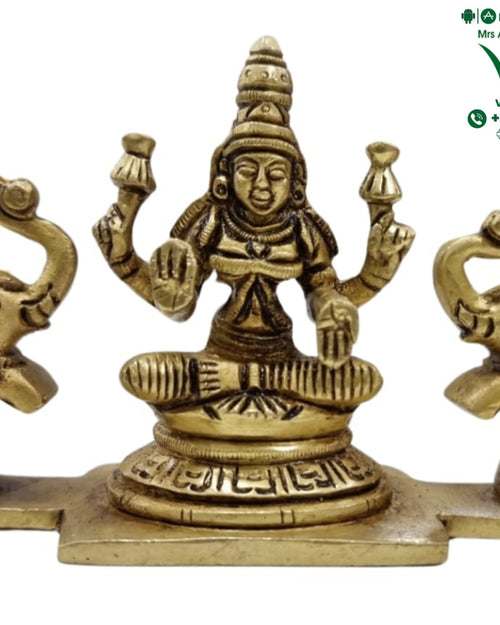 Gajalakshmi in brass, seated figure on a lotus flanked by two elephants with raised trunks facing inward