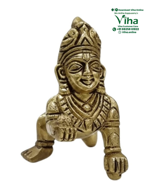 Child Krishna in brass, crawling figure with outstretched limbs, a crown and engraved jewellery