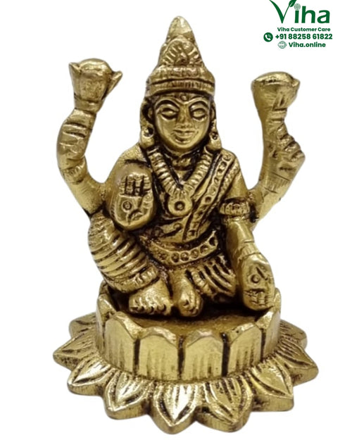 Mahalakshmi in brass, four-armed figure seated on a scalloped petal base