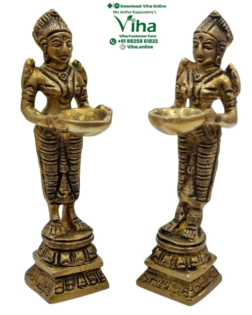Paavai vilakku, pair of standing brass figures each holding a shallow oil bowl in cupped hands
