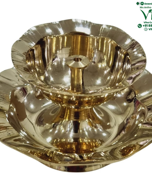 Brass double decker lamp, scalloped oil bowl with central wick pin above a wider scalloped dish