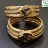 Impon Toe Ring, two gold-toned textured rings with braided details and a central faceted stone are stacked vertically on a dark surface