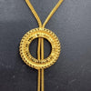 Impon Chain with Pendant, a gold-toned textured chain holds a circular pendant with two dangling beaded ends