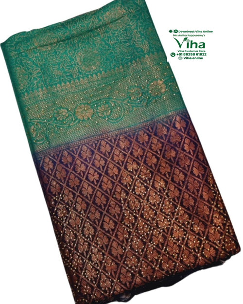 Soft Silk Saree with Stone Work, a folded fabric with green upper section and dark brown lower section featuring gold-toned floral patterns and diamond lattice