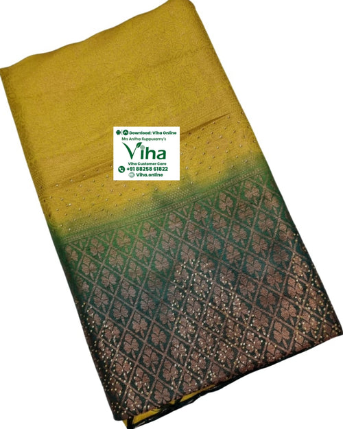 Soft Silk Saree with Stone Work, folded yellow and dark green textile with a patterned border and small sparkly dots
