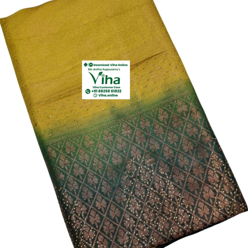 Soft Silk Saree with Stone Work, folded yellow and dark green textile with a patterned border and small sparkly dots