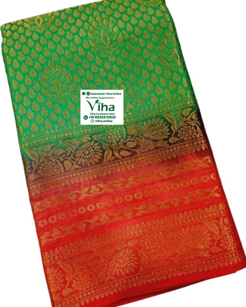 Soft Silk Saree With Blouse, a folded green and red textile piece featuring gold-toned woven patterns with leafy motifs and floral borders