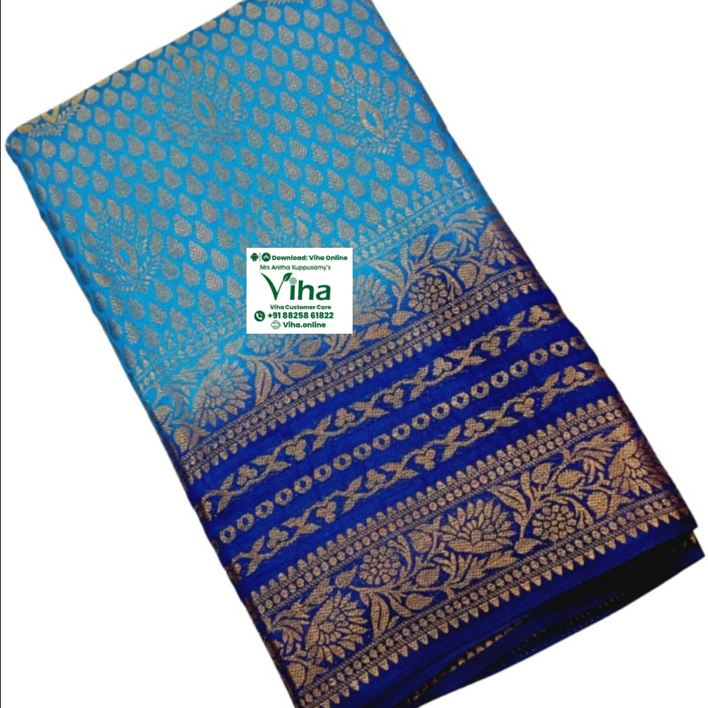 Soft Silk Saree With Blouse, a blue folded fabric with gold-toned patterns featuring leaf motifs and floral borders