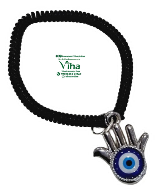 Hansa Hand Evil Eye Anklet, a black coiled elastic band features a silver-coloured hand-shaped charm with a circular blue and white eye-patterned centerpiece