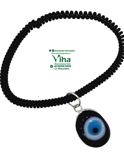 Evil Eye Anklet, a spiral band with a blue, white and black glass eye pendant
